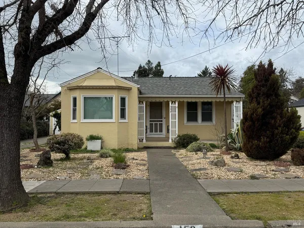 a front view of a house with a yard