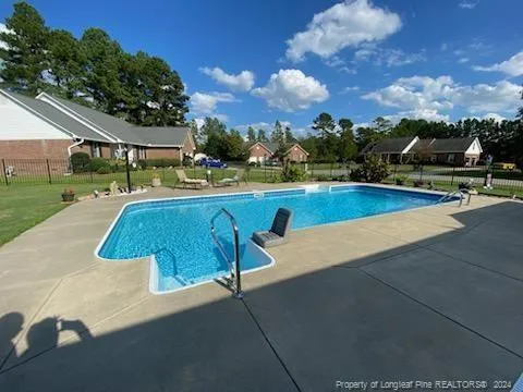a view of a swimming pool with an outdoor seating and a garden