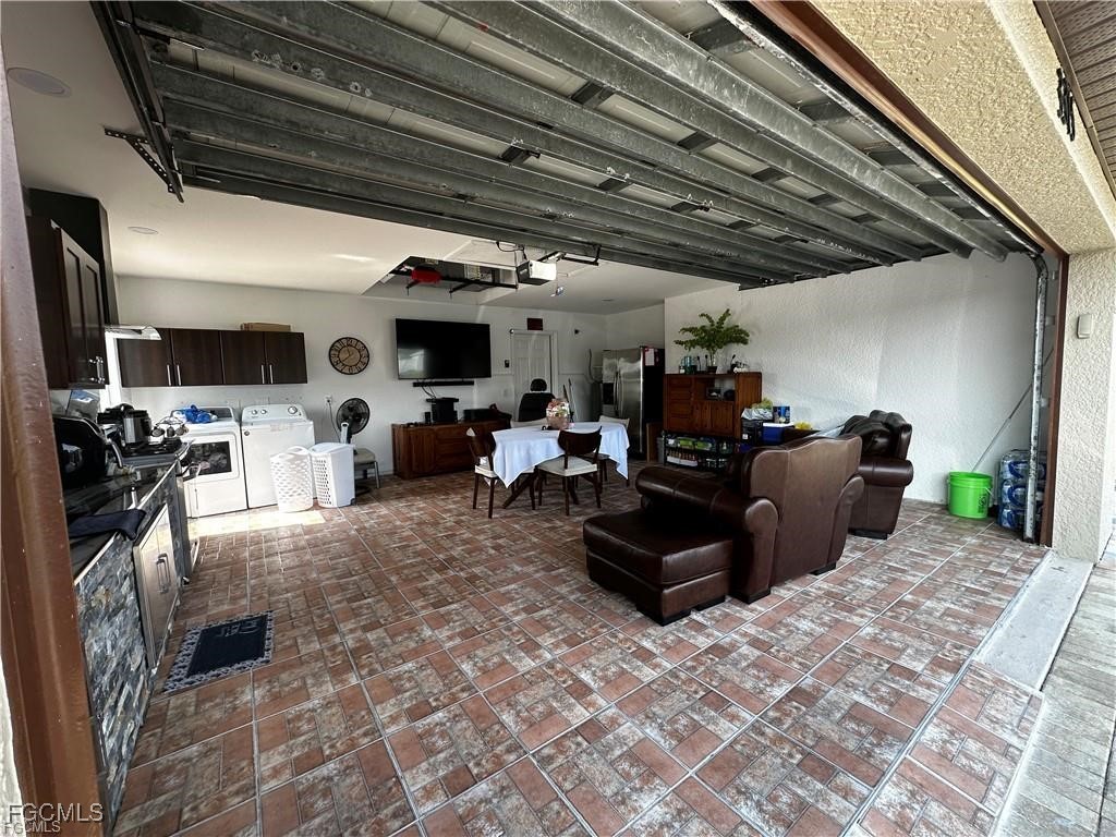 3315 37th Street Southwest Lehigh Acres, FL 33976 - Photo 11 of 34 a living room with furniture appliances and a kitchen view