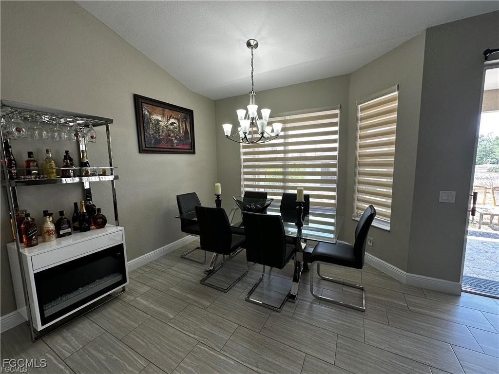 3315 37th Street Southwest Lehigh Acres, FL 33976 - Photo 15 of 34 a dining room with furniture and window