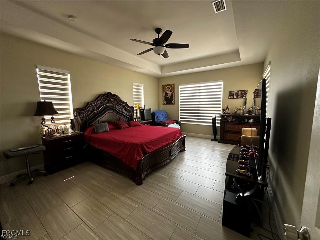 3315 37th Street Southwest Lehigh Acres, FL 33976 - Photo 19 of 34 a bedroom with a bed dresser and a window