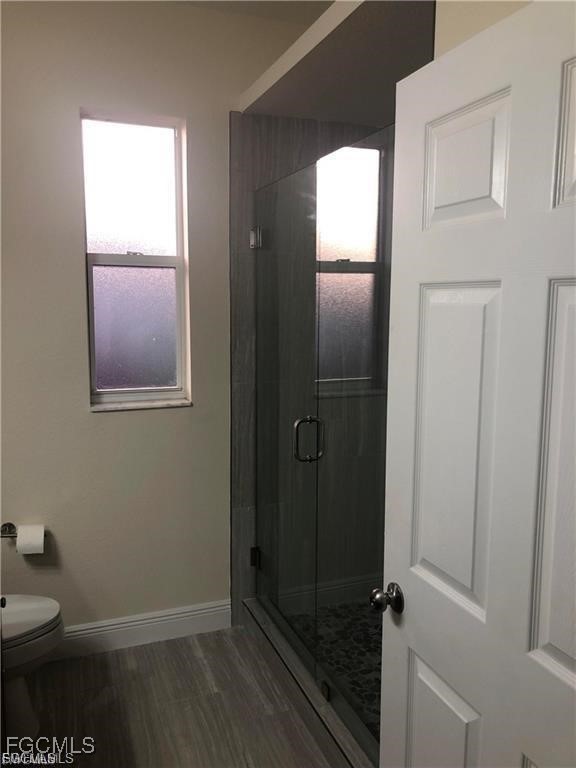 3315 37th Street Southwest Lehigh Acres, FL 33976 - Photo 29 of 34 a bathroom with a toilet