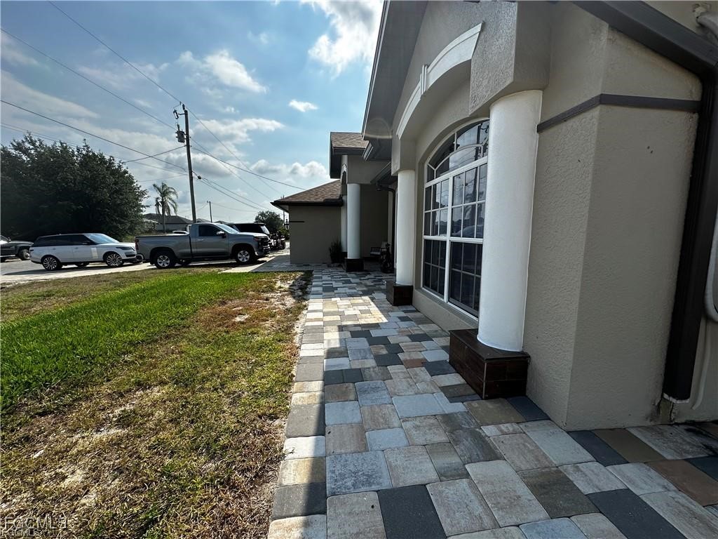 3315 37th Street Southwest Lehigh Acres, FL 33976 - Photo 4 of 34 a view of a patio with table and chairs potted plants with wooden floor