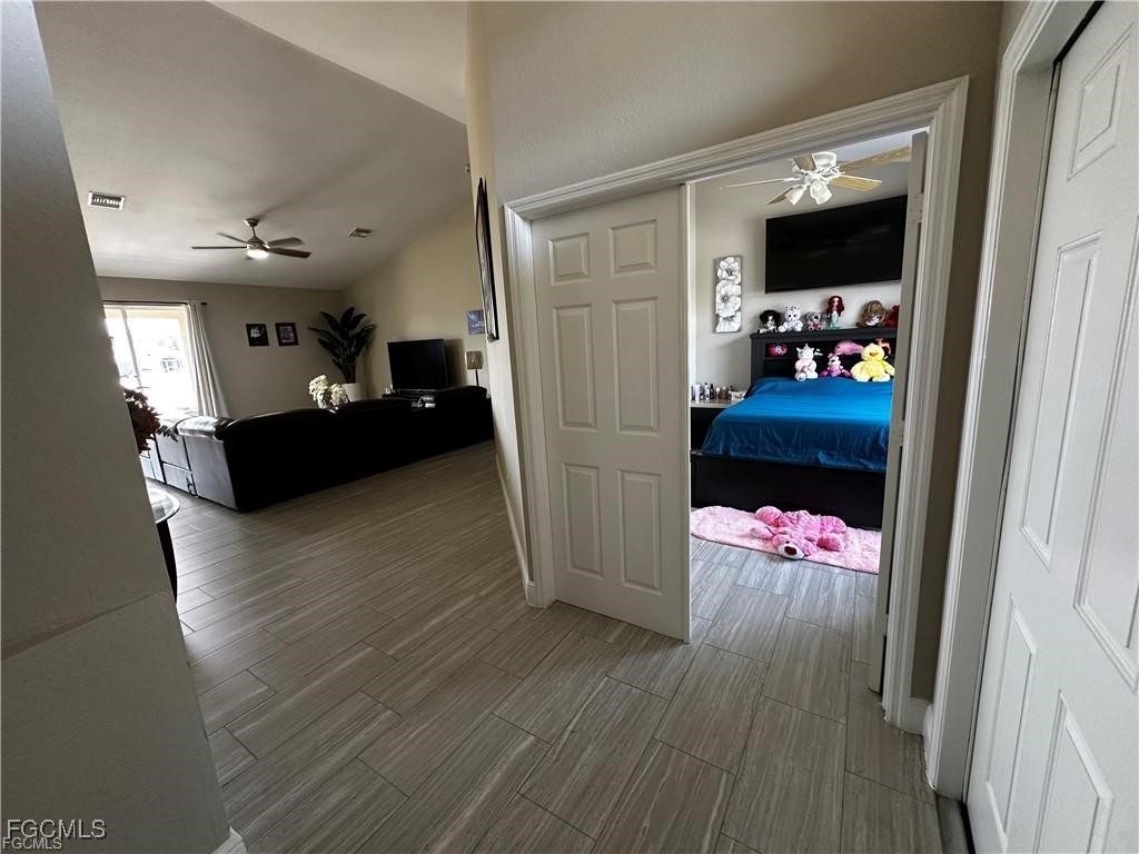 3315 37th Street Southwest Lehigh Acres, FL 33976 - Photo 7 of 34 a living room with furniture and a flat screen tv