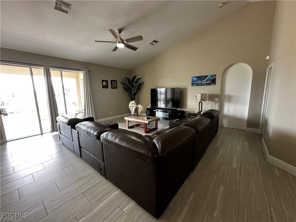 3315 37th Street Southwest Lehigh Acres, FL 33976 - Photo 8 of 34 a living room with furniture and a large window
