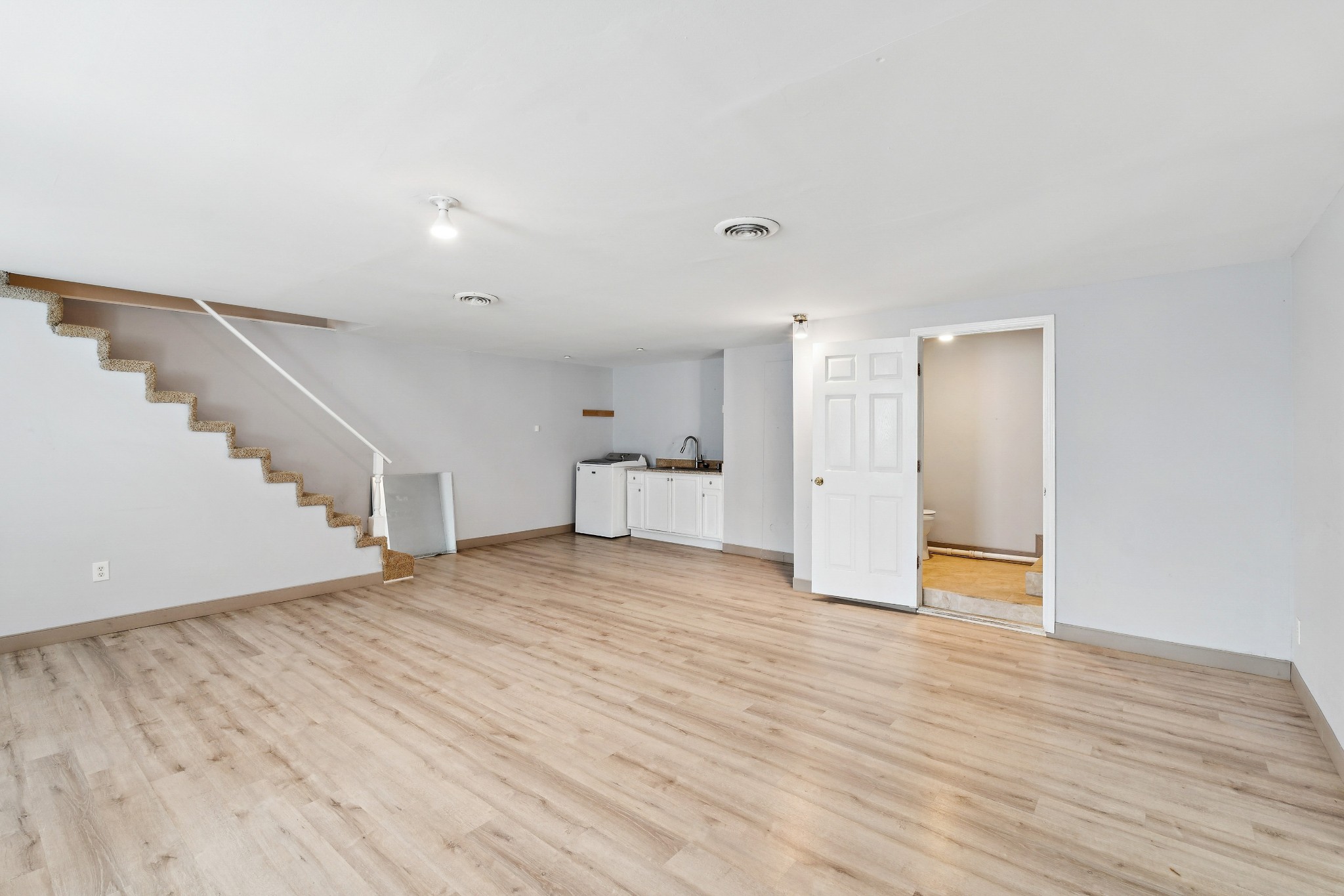 1205 Jacksons Hill Road Hermitage, TN 37076 - Photo 14 of 28 a view of an empty room with wooden floor and stairs