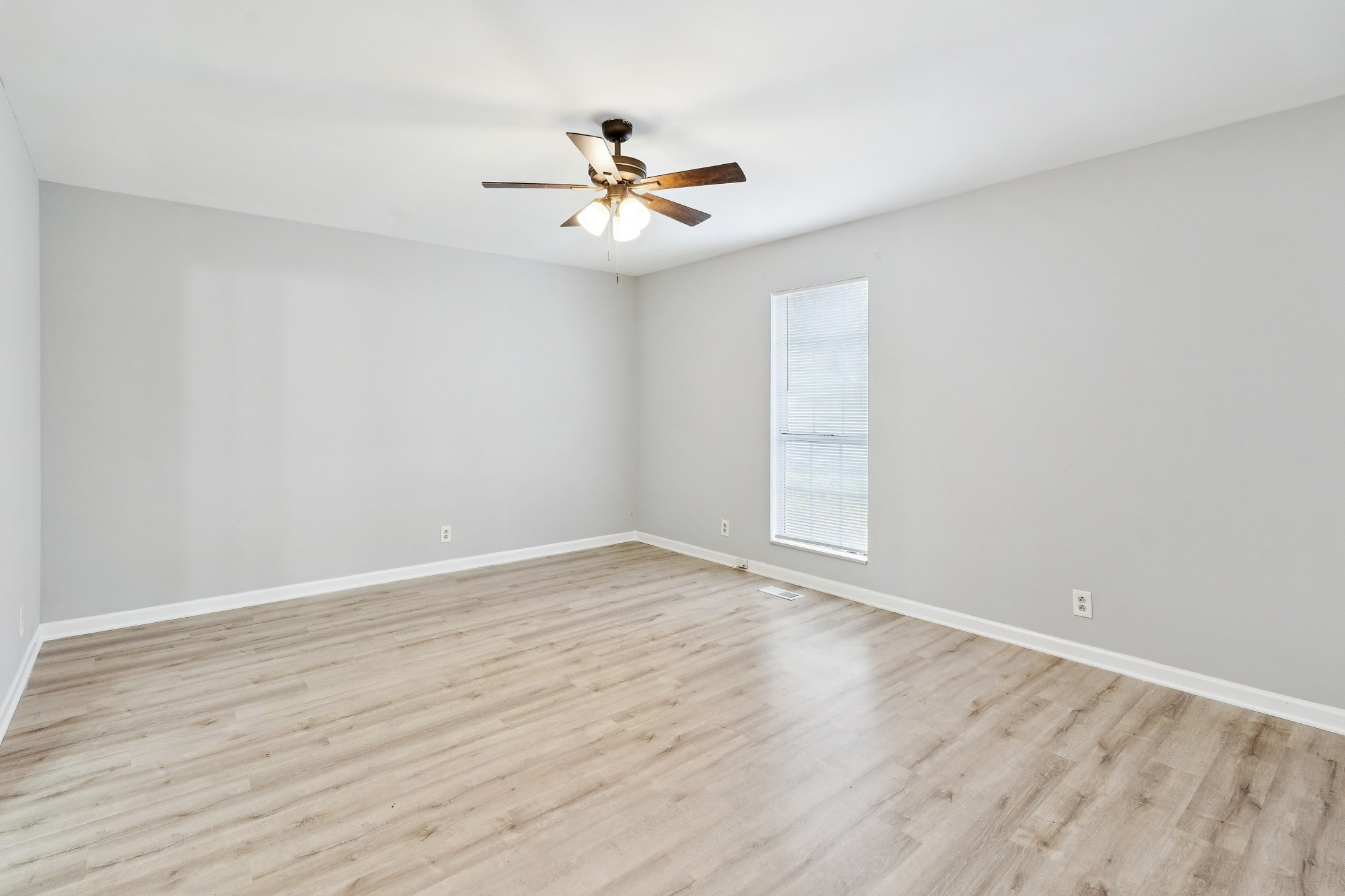 1205 Jacksons Hill Road Hermitage, TN 37076 - Photo 3 of 28 an empty room with wooden floor chandelier fan and windows