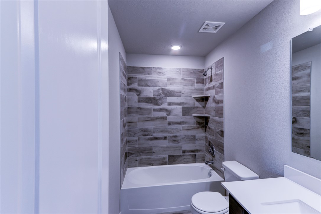 1937 Viva Road Bryan, TX 77807 - Photo 16 of 25 a bathroom with a tub and toilet