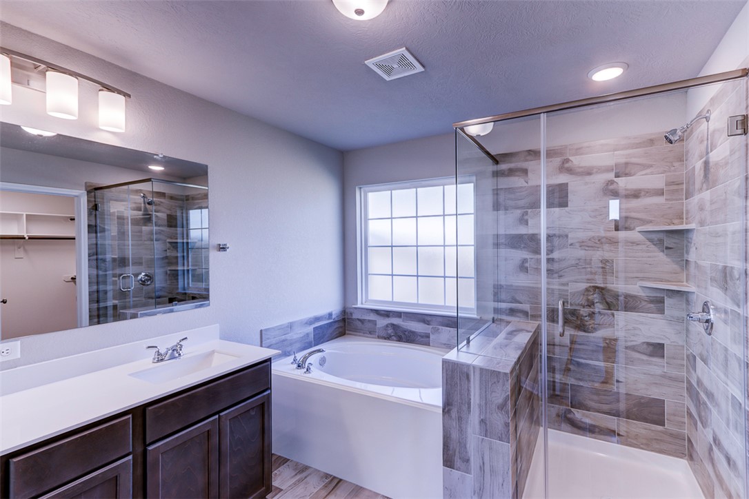 1937 Viva Road Bryan, TX 77807 - Photo 20 of 25 a bathroom with a bathtub sink vanity granite and shower
