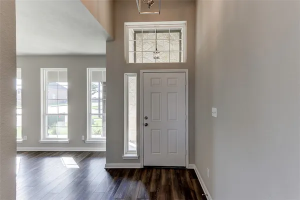 a view of front door with wooden floor