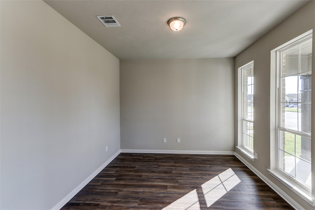 1937 Viva Road Bryan, TX 77807 - Photo 4 of 25 a view of an empty room with wooden floor and a window