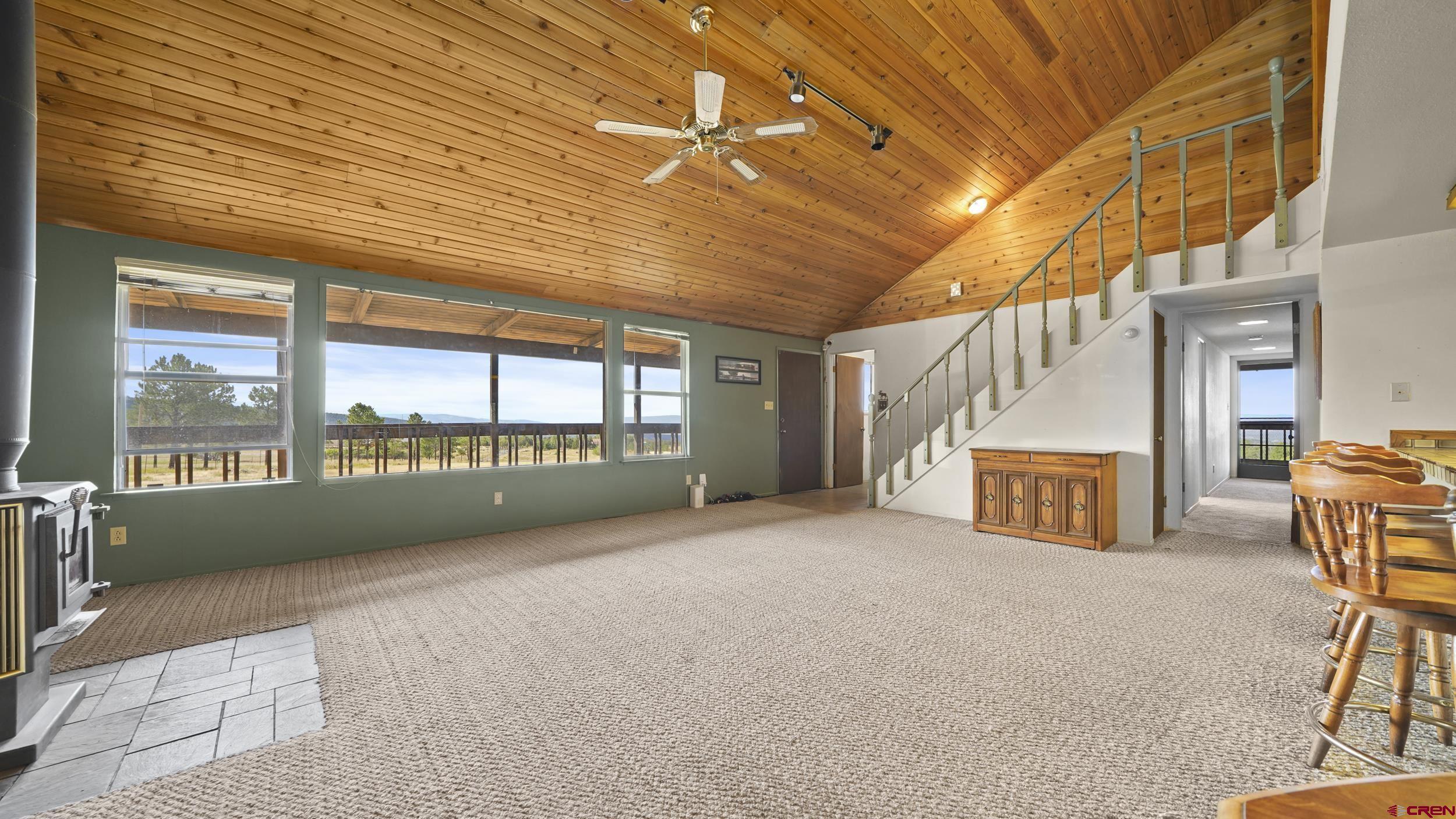 19617 Surface Creek Road Cedaredge, CO 81413 - Photo 4 of 34 a view of an empty room with a fireplace and a window