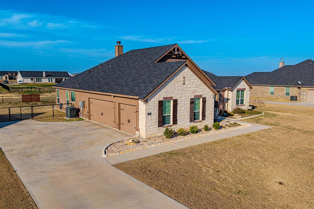 150 Oak Grove Drive Rhome, TX 76078 - Photo 2 of 40 a view of a house with wooden fence