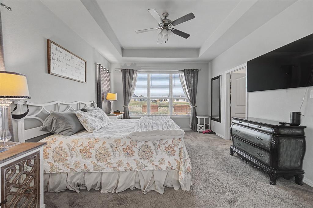 150 Oak Grove Drive Rhome, TX 76078 - Photo 23 of 40 a bedroom with a bed and a flat screen tv