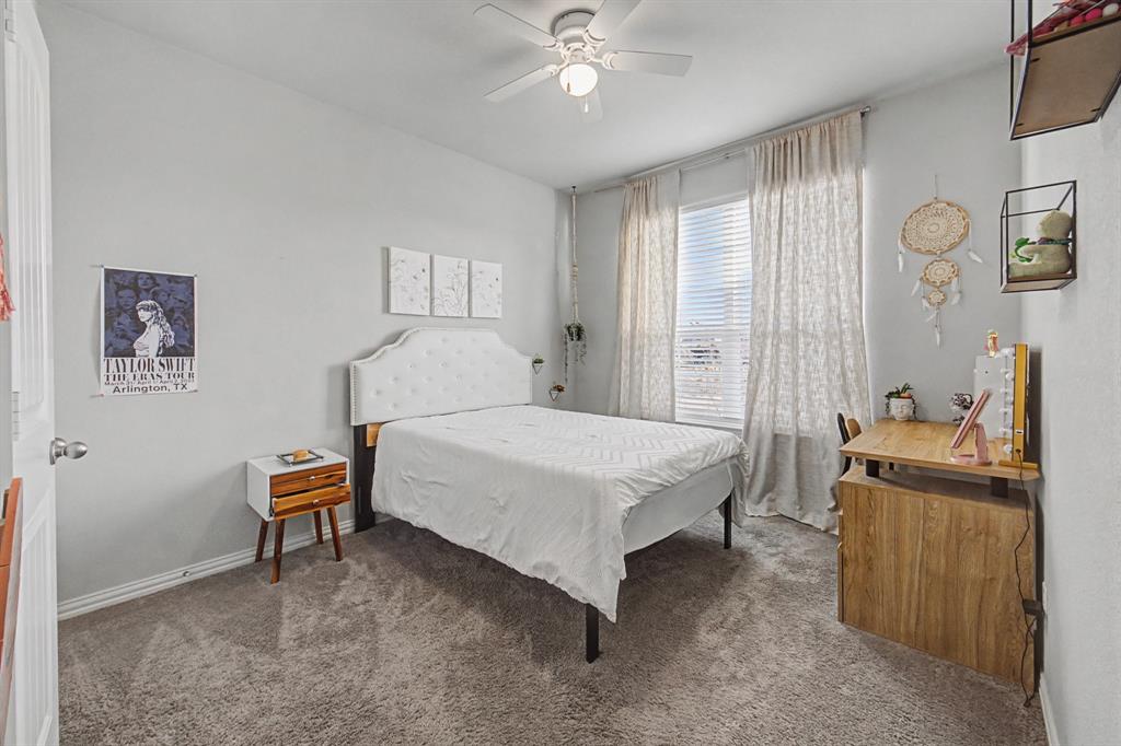 150 Oak Grove Drive Rhome, TX 76078 - Photo 26 of 40 a bedroom with a bed and a chandelier