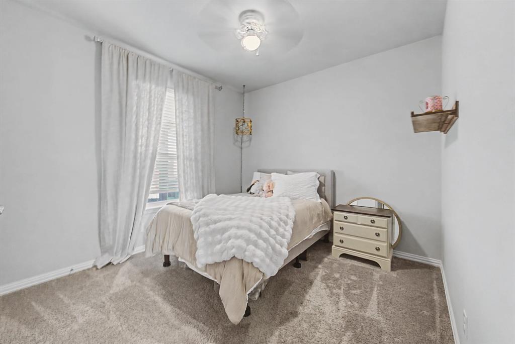 150 Oak Grove Drive Rhome, TX 76078 - Photo 27 of 40 a bedroom with a bed and a window