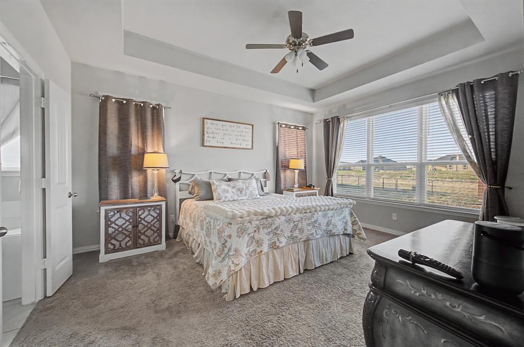 150 Oak Grove Drive Rhome, TX 76078 - Photo 28 of 40 a bed room with a bed and a couch