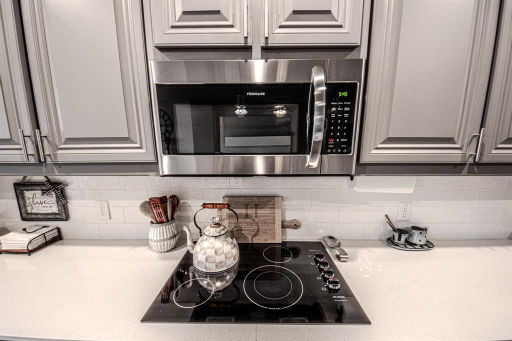 150 Oak Grove Drive Rhome, TX 76078 - Photo 29 of 40 a kitchen with a stove and a microwave