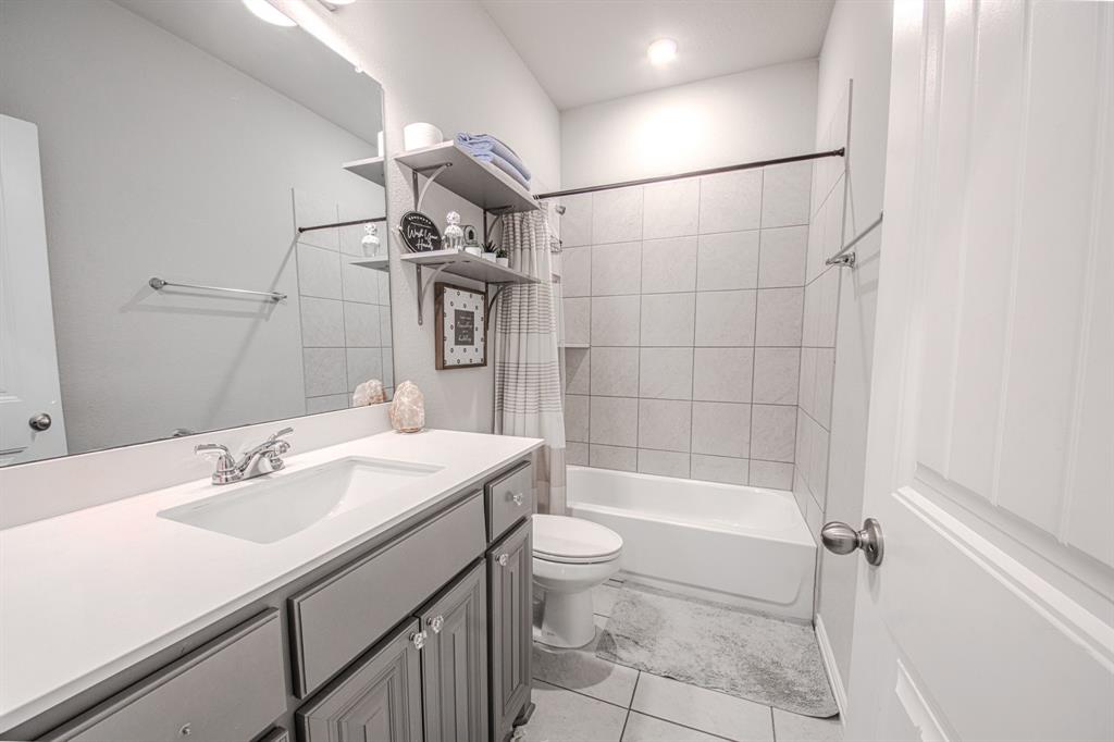 150 Oak Grove Drive Rhome, TX 76078 - Photo 31 of 40 a bathroom with a sink a toilet and shower