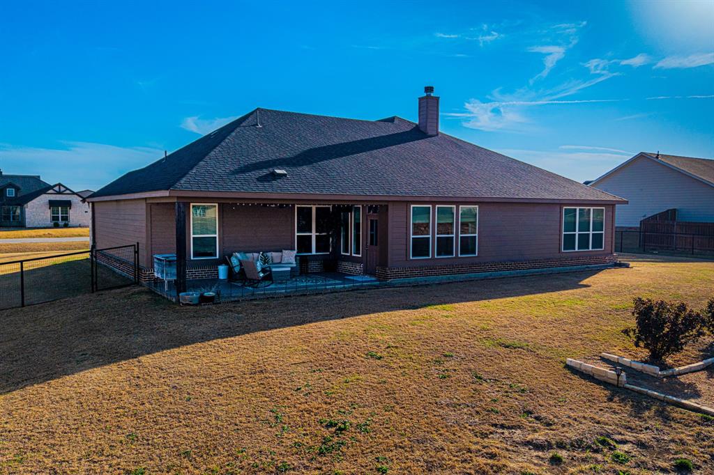 150 Oak Grove Drive Rhome, TX 76078 - Photo 35 of 40 a front view of a house with a yard