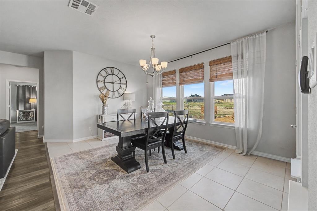 150 Oak Grove Drive Rhome, TX 76078 - Photo 8 of 40 a view of a dining room with furniture window and wooden floor