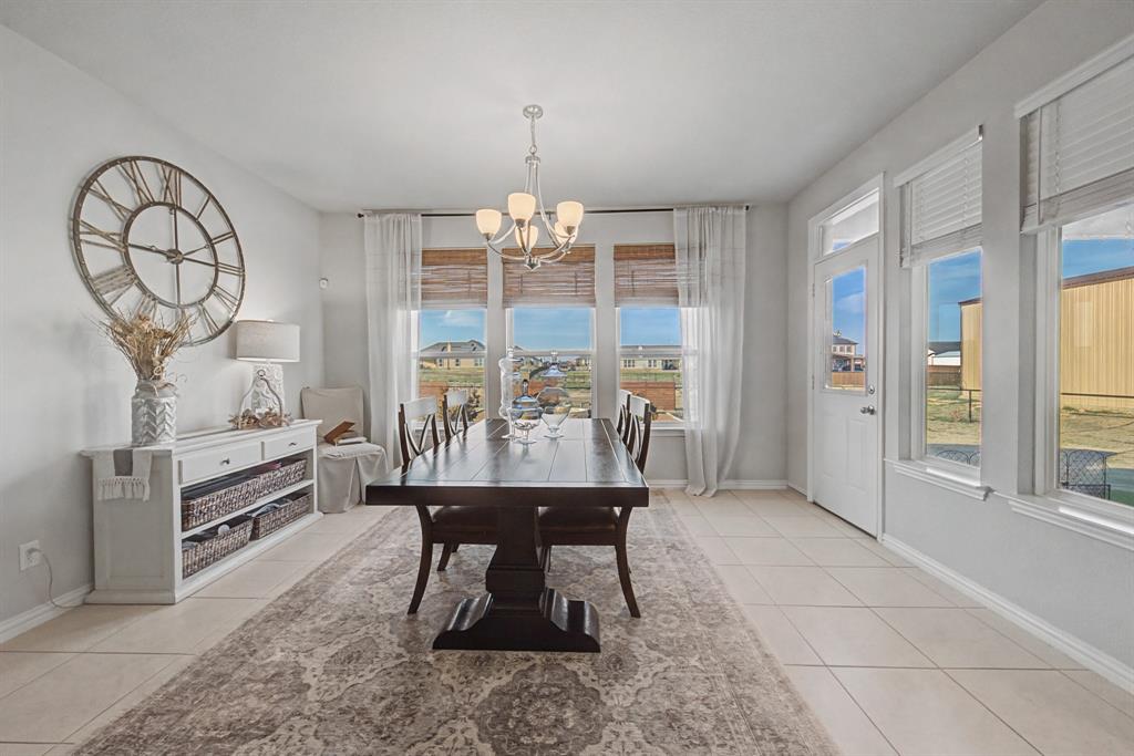 150 Oak Grove Drive Rhome, TX 76078 - Photo 9 of 40 a dining room with furniture a chandelier and a rug