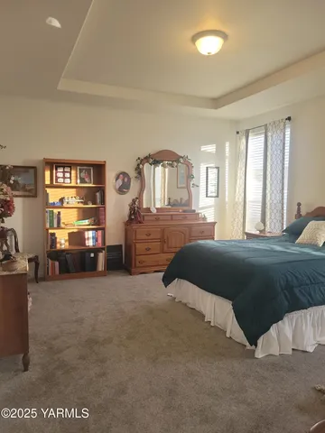 a bedroom with a bed and a night stand