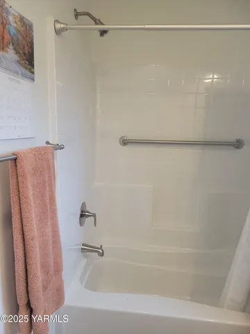 a bathroom with a shower and a bath tub