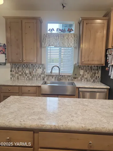 a bathroom with mirror sink and window