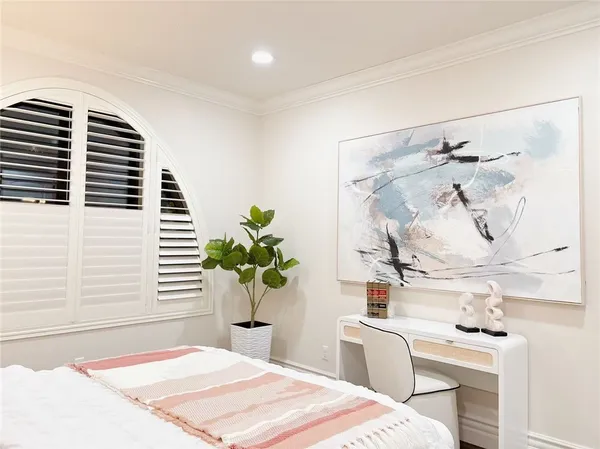 a spacious bedroom with a bed and a window