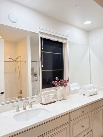 a view of kitchen with granite countertop stove top oven and refrigerator