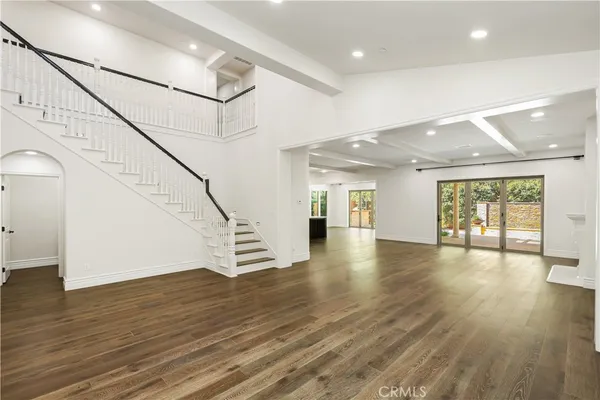 a view of hallway with a large window and wooden floor