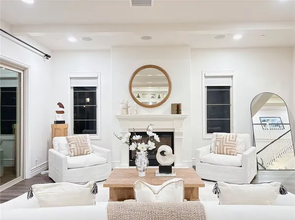 a dining room with furniture a large window and wooden floor
