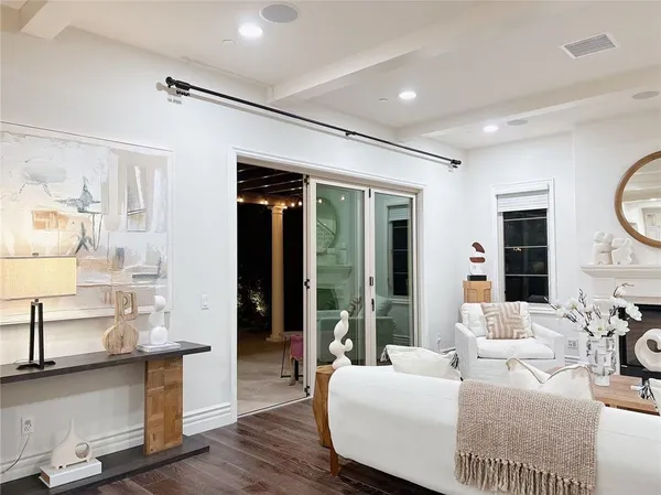 a kitchen with stainless steel appliances kitchen island granite countertop a dining table chairs and a refrigerator