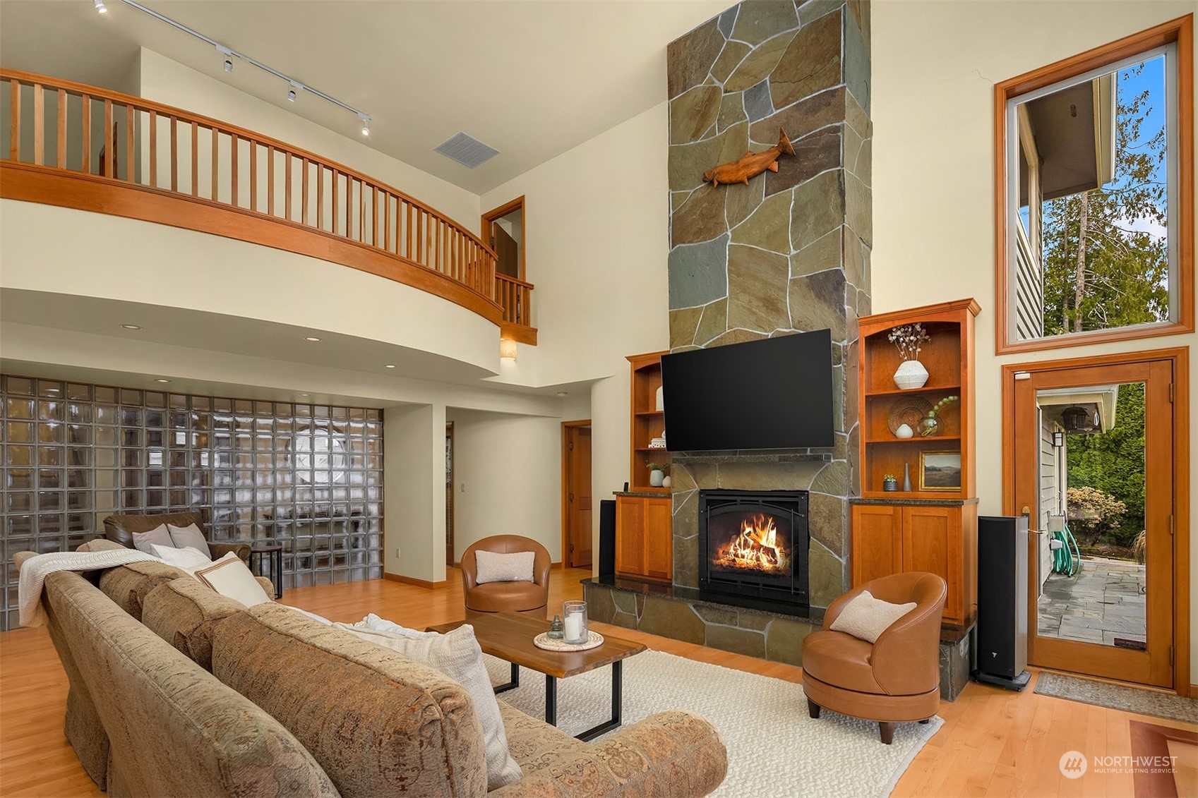 49 Strawberry Point Road Bellingham, WA 98229 - Photo 12 of 40 a living room with furniture a flat screen tv and a fireplace