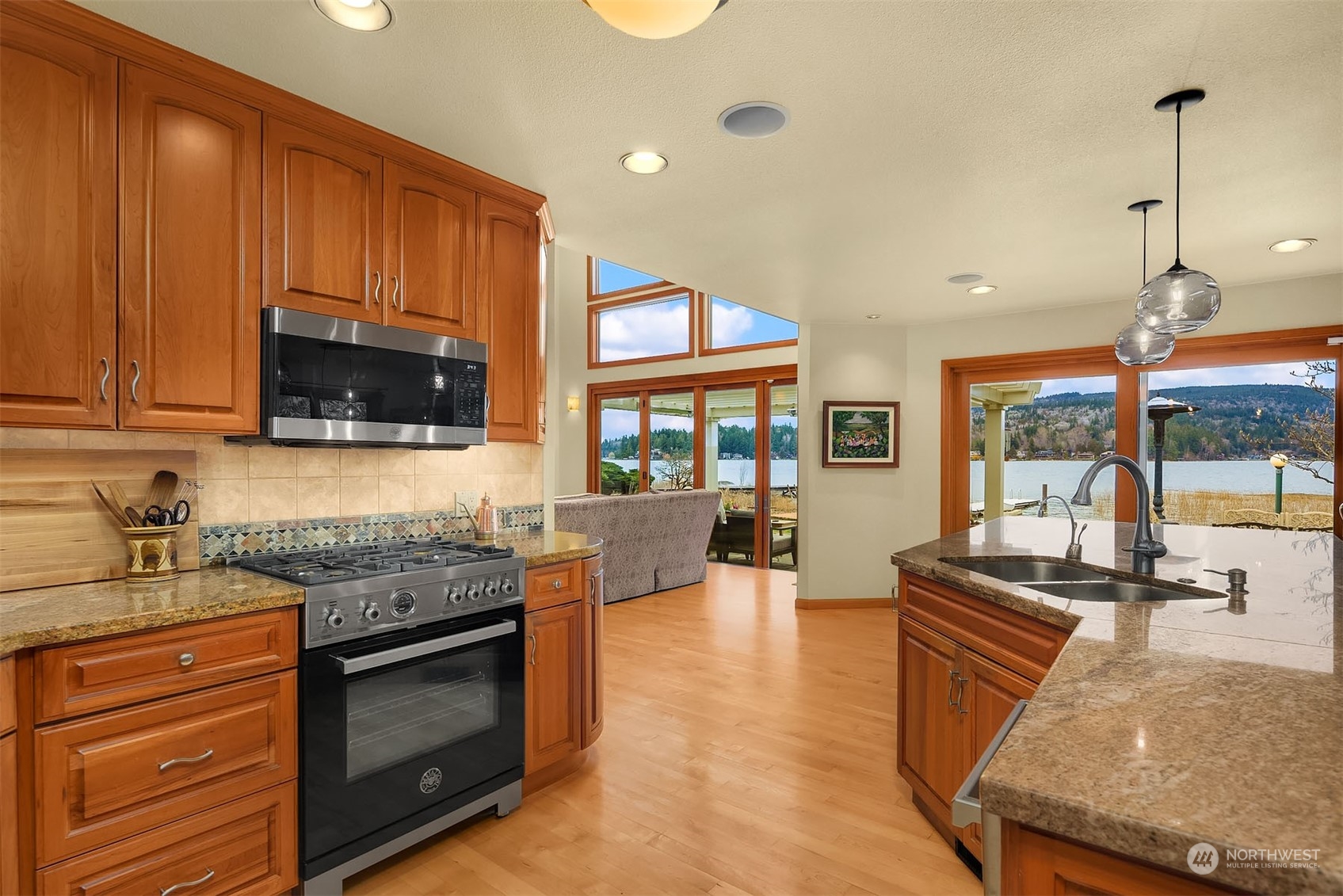 49 Strawberry Point Road Bellingham, WA 98229 - Photo 13 of 40 a kitchen with stainless steel appliances granite countertop a stove a sink and a microwave