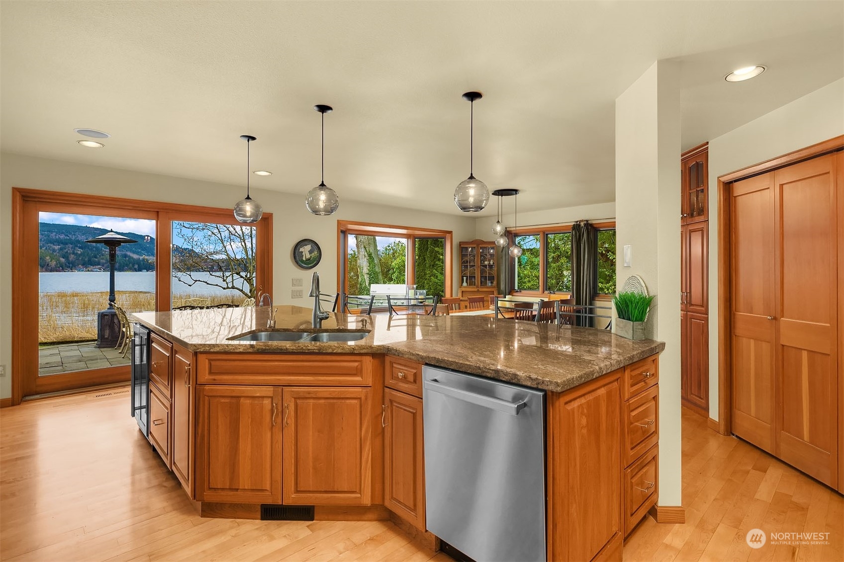 49 Strawberry Point Road Bellingham, WA 98229 - Photo 15 of 40 a kitchen with stainless steel appliances granite countertop a sink and a wooden floors