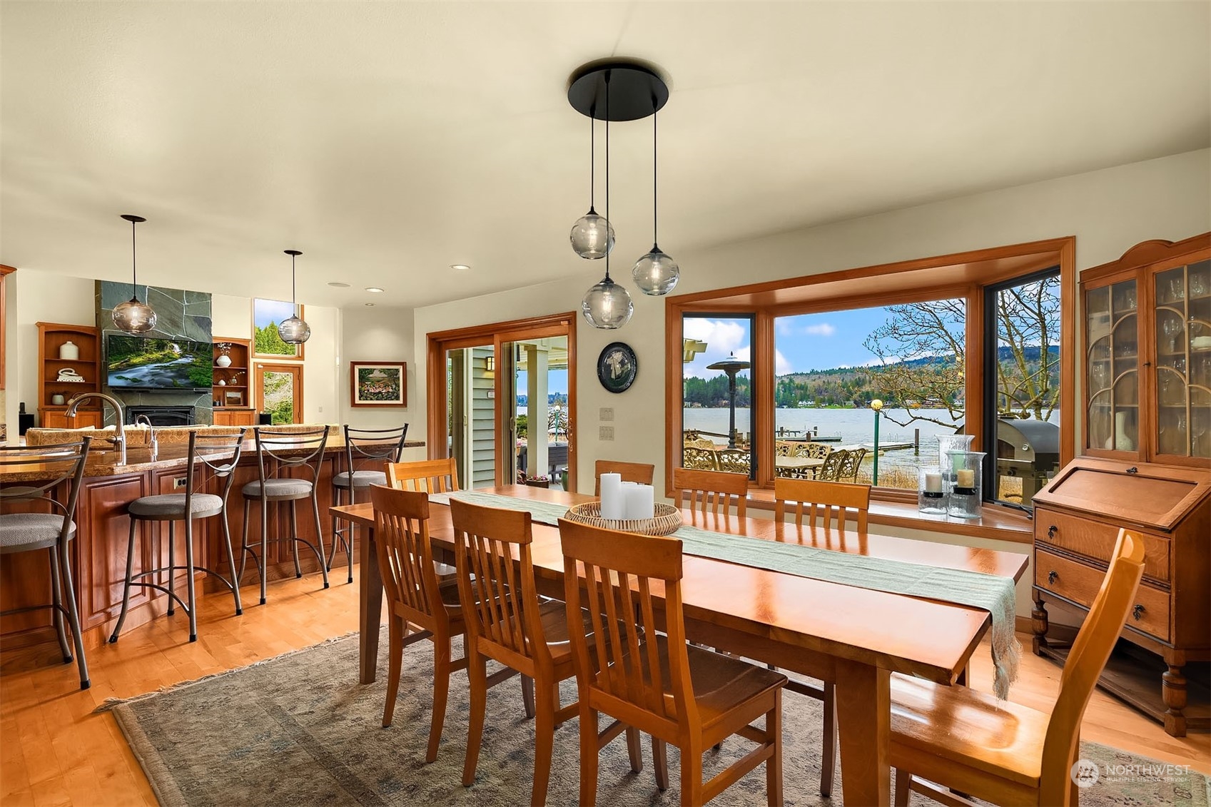 49 Strawberry Point Road Bellingham, WA 98229 - Photo 16 of 40 a view of a dining room with furniture large windows and wooden floor
