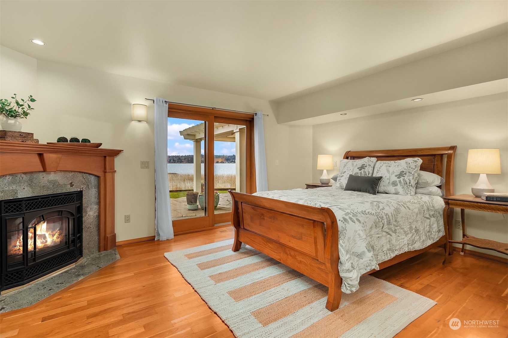 49 Strawberry Point Road Bellingham, WA 98229 - Photo 19 of 40 a spacious bedroom with a bed and a fireplace
