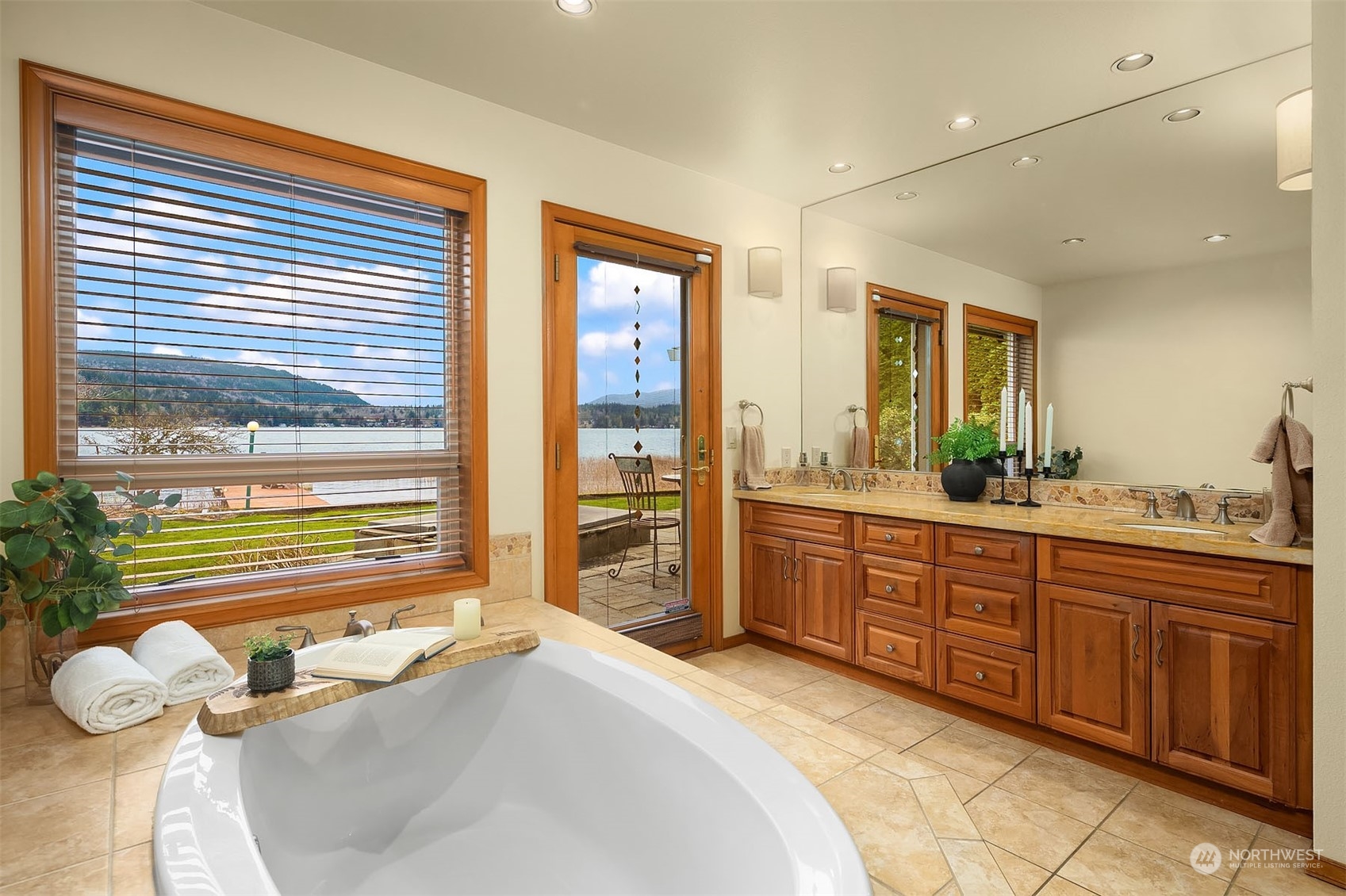 49 Strawberry Point Road Bellingham, WA 98229 - Photo 21 of 40 a spacious bathroom with a granite countertop sink and a large mirror