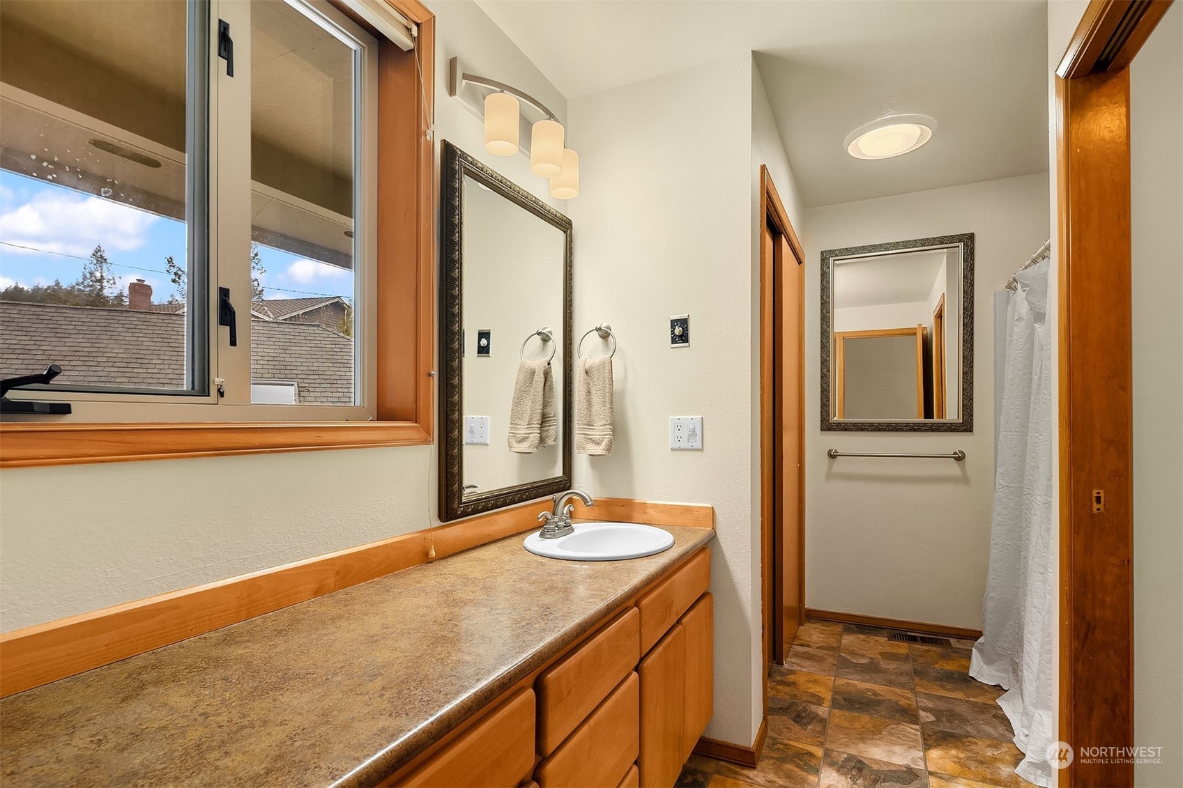 49 Strawberry Point Road Bellingham, WA 98229 - Photo 30 of 40 a bathroom with a sink and a mirror