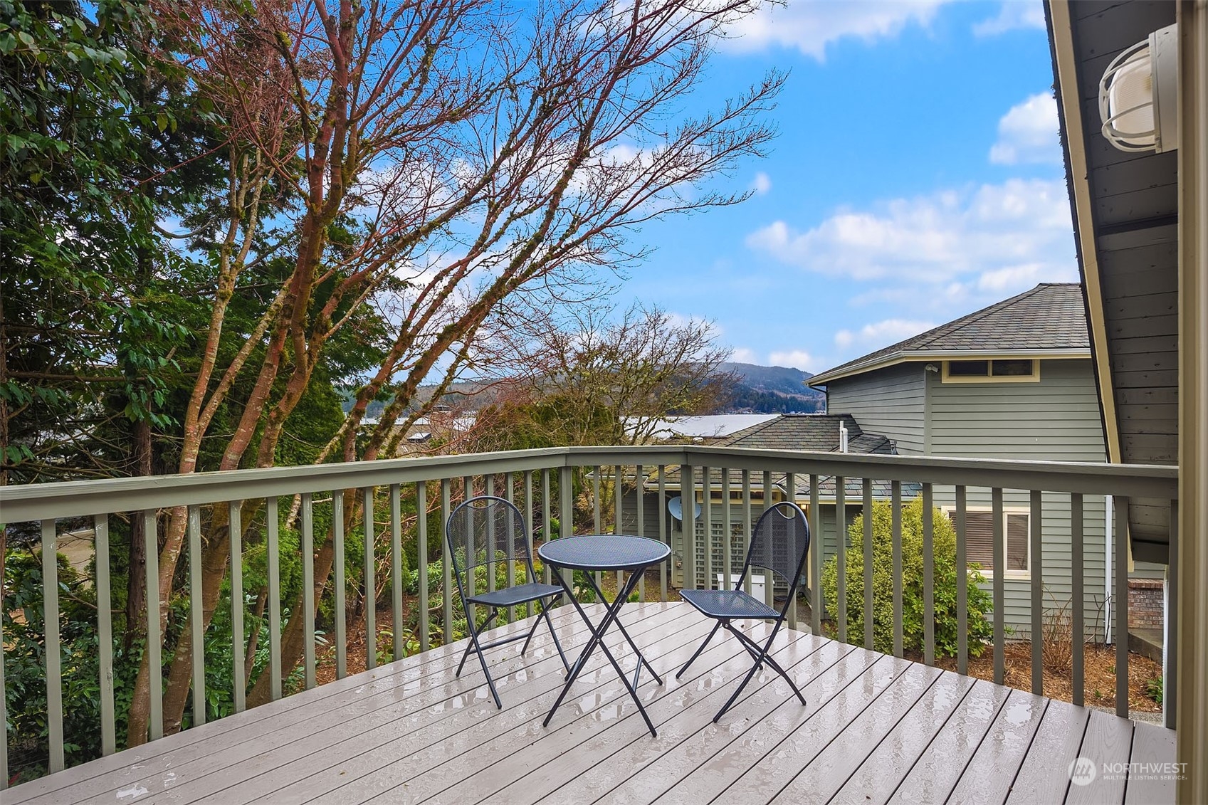49 Strawberry Point Road Bellingham, WA 98229 - Photo 35 of 40 a balcony with wooden floor table and chairs