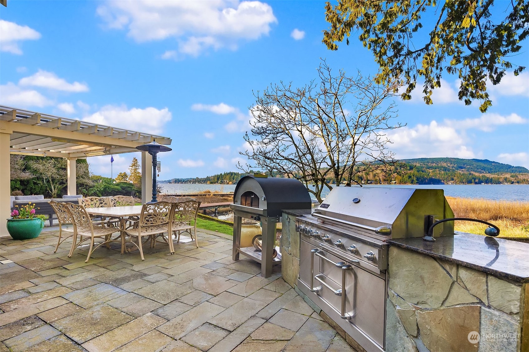 49 Strawberry Point Road Bellingham, WA 98229 - Photo 8 of 40 a roof deck with table and chairs under an umbrella