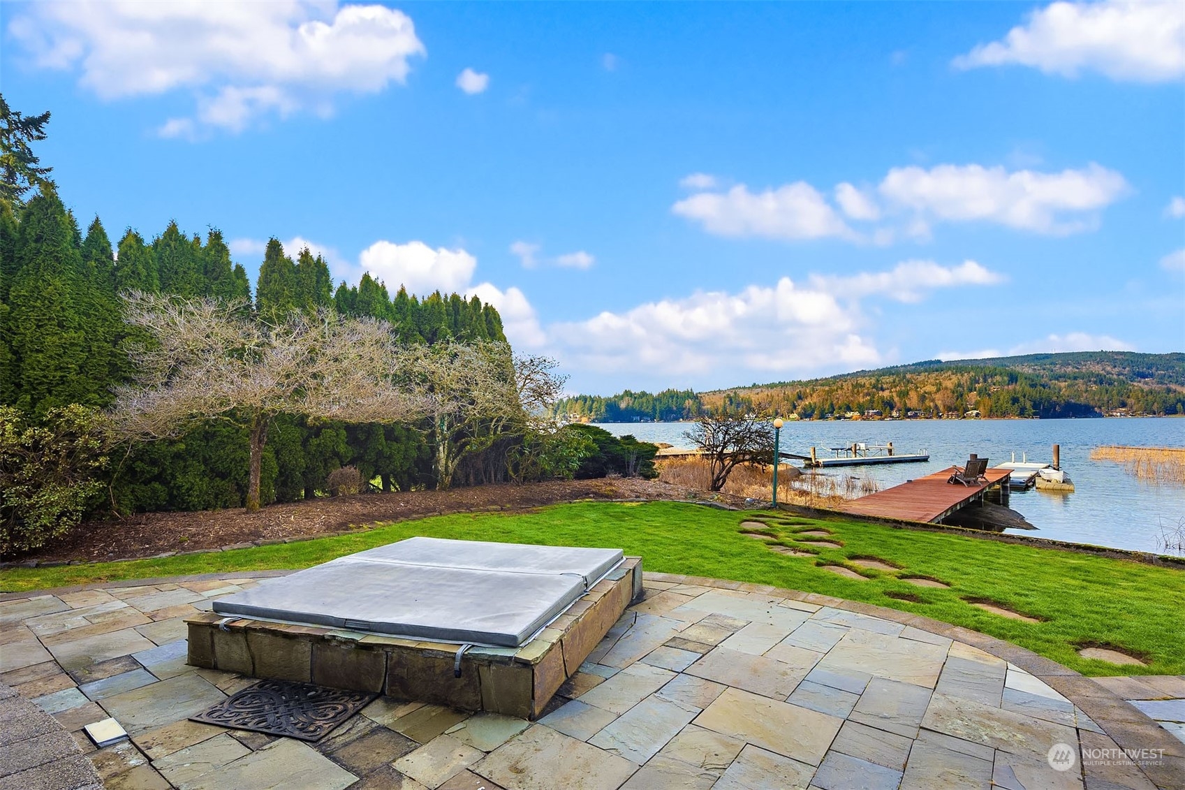 49 Strawberry Point Road Bellingham, WA 98229 - Photo 9 of 40 a view of a swimming pool and lounge chairs in back yard of the house