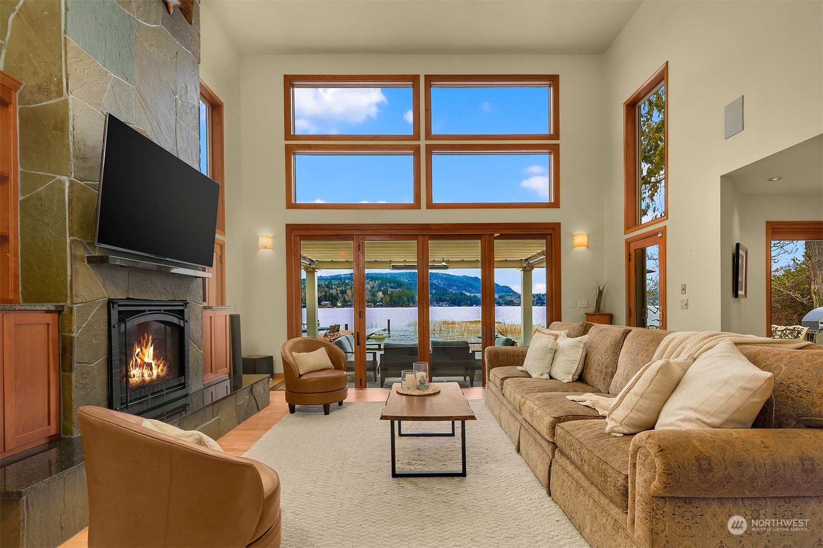 49 Strawberry Point Road Bellingham, WA 98229 - Photo 10 of 40 a living room with furniture a fireplace and a flat screen tv
