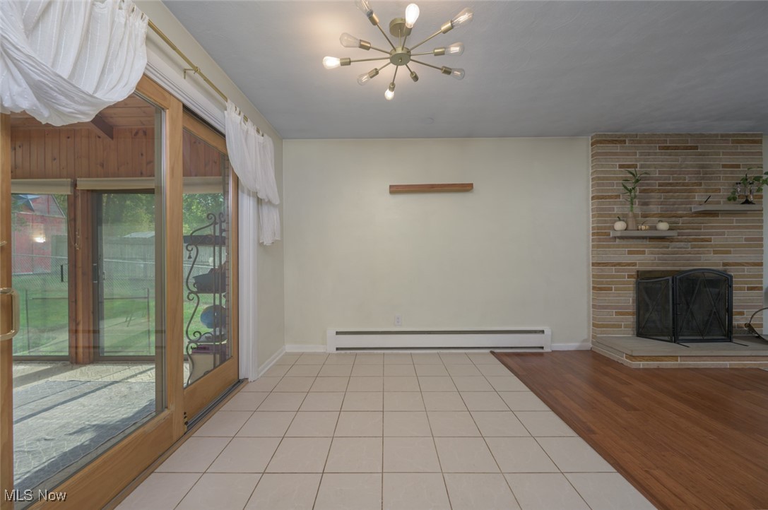 1177 Munroe Falls Kent Road Kent, OH 44240 - Photo 29 of 47 Dining room featuring ceramic flooring, a baseboard heating unit, and a healthy amount of sunlight