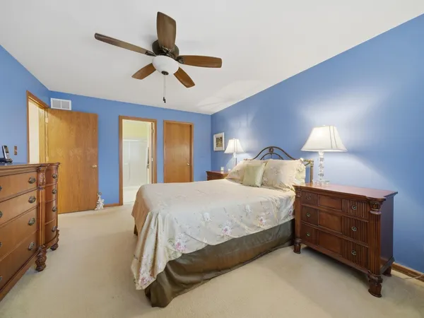 a bed room with a bed and a chandelier