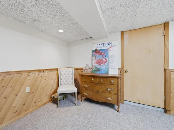 a view of an empty room with a painting on the wall