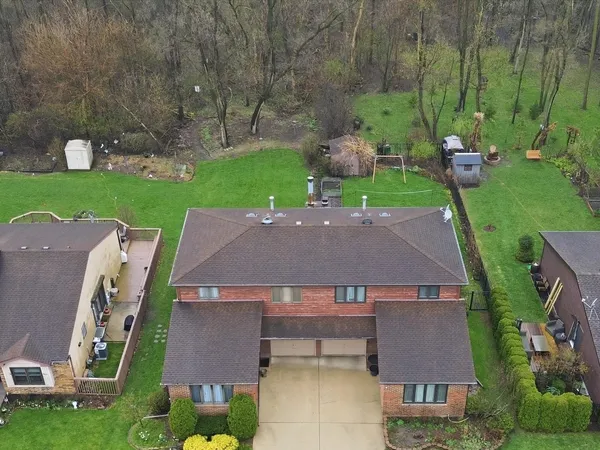 an aerial view of a house with garden space and street view