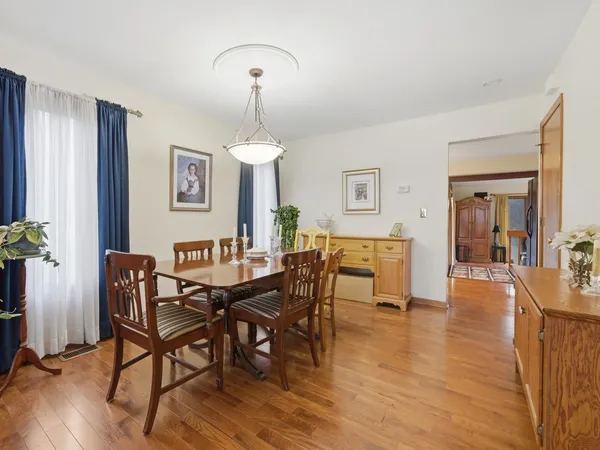 a view of a dining room with furniture and wooden floor